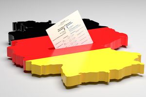 Elections in Germany. A sample ballot paper for the election to the Bundestag in the slit of a ballot box in the form of the German map with the German flag. 3d render, gray background, copy space